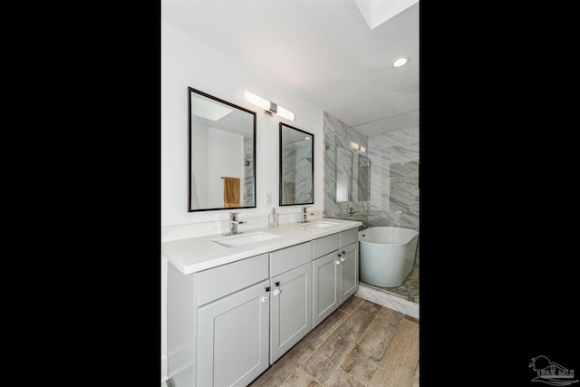 bathroom featuring vanity, hardwood / wood-style floors, and independent shower and bath