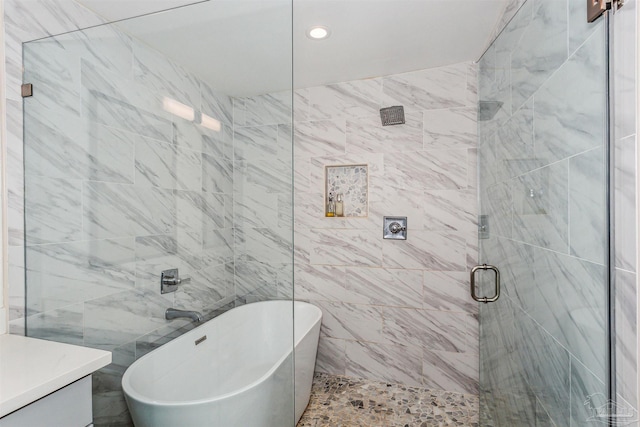 bathroom featuring separate shower and tub and tile walls