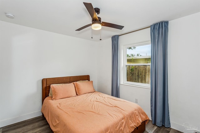 bedroom with ceiling fan and dark wood-type flooring