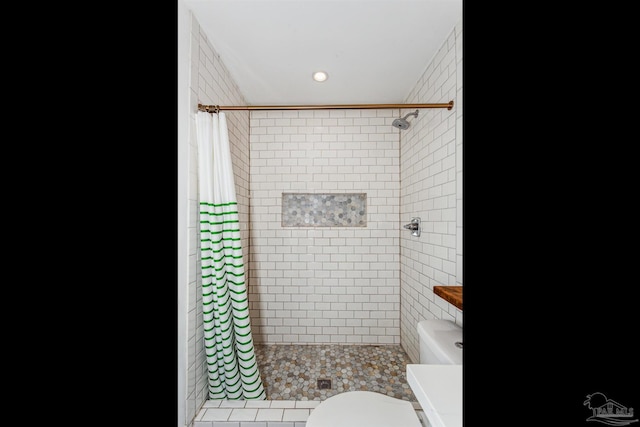 bathroom with a shower with curtain and toilet