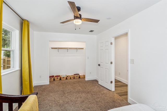 carpeted bedroom with a closet and ceiling fan