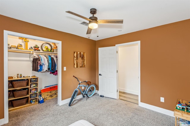 recreation room with ceiling fan and carpet