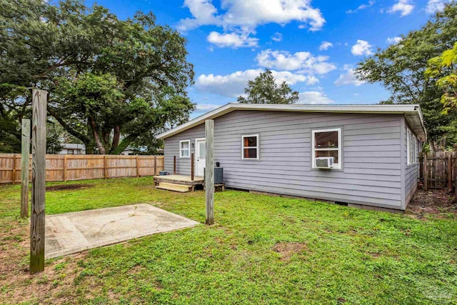 back of house featuring a yard, a patio area, and a wooden deck