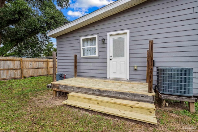 property entrance featuring a deck and central air condition unit