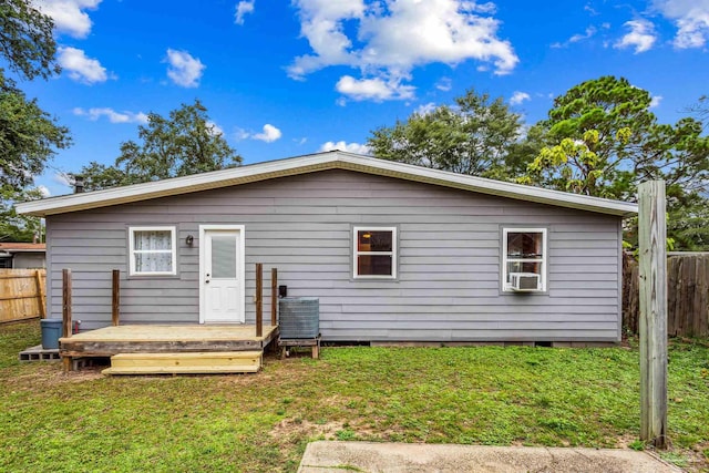 rear view of house with a yard and a wooden deck