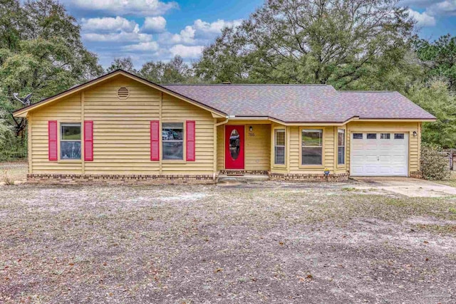 ranch-style house with a garage, roof with shingles, and driveway