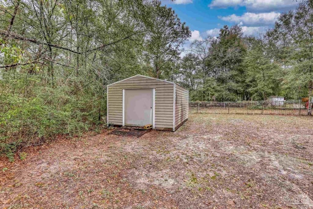 view of shed featuring fence