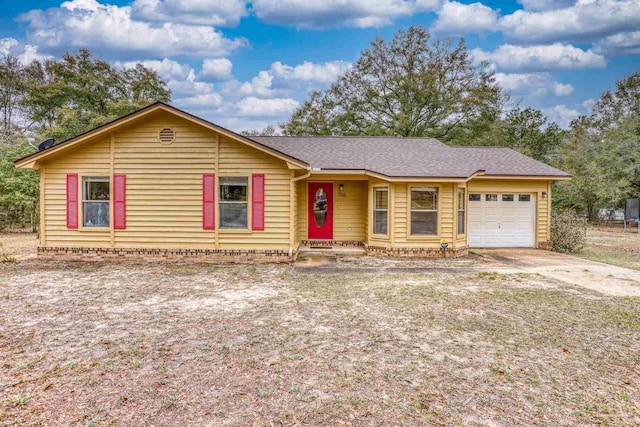 view of front of property featuring a garage, driveway, and a shingled roof