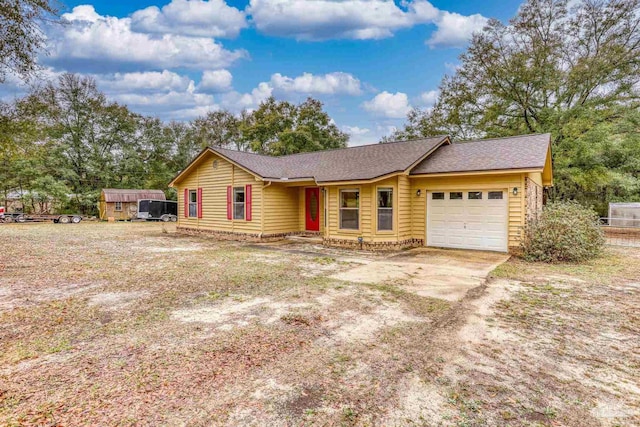 single story home featuring an attached garage and driveway