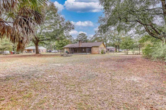 view of yard featuring a sunroom