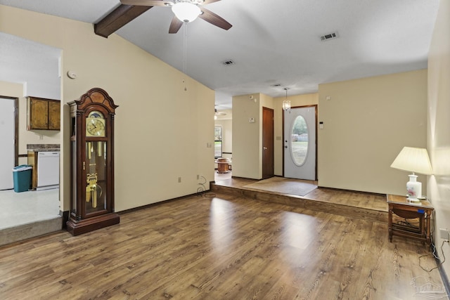 foyer entrance with visible vents, lofted ceiling with beams, a ceiling fan, and wood finished floors