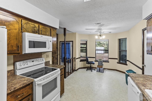 kitchen featuring visible vents, a ceiling fan, a textured ceiling, white appliances, and light floors