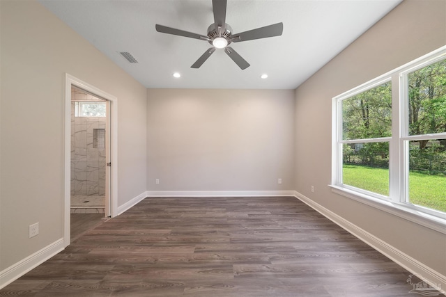 spare room featuring dark hardwood / wood-style floors, a healthy amount of sunlight, and ceiling fan