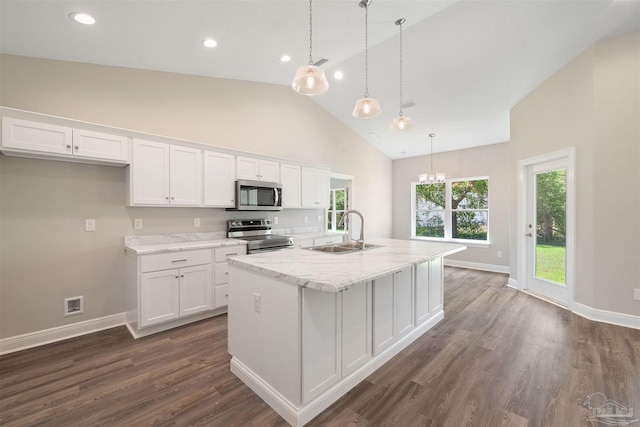 kitchen with sink, white cabinetry, stainless steel appliances, and a kitchen island with sink