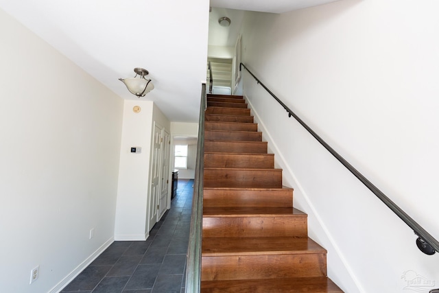 stairway featuring tile patterned floors