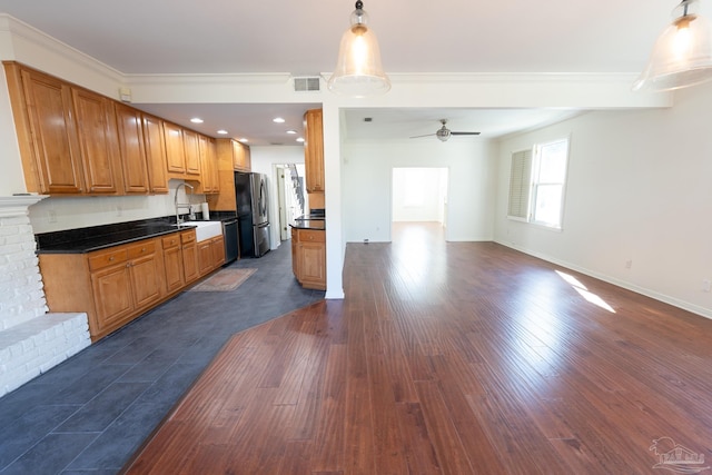 kitchen with a fireplace, dark hardwood / wood-style flooring, stainless steel appliances, and ceiling fan