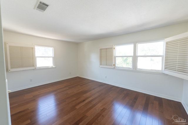 spare room featuring dark hardwood / wood-style floors