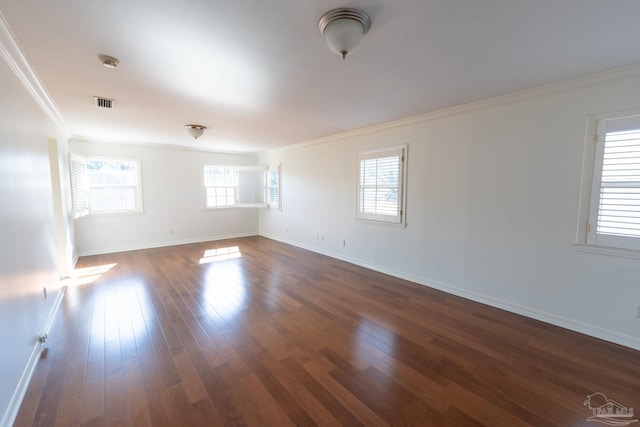 spare room with crown molding, dark hardwood / wood-style flooring, and a healthy amount of sunlight