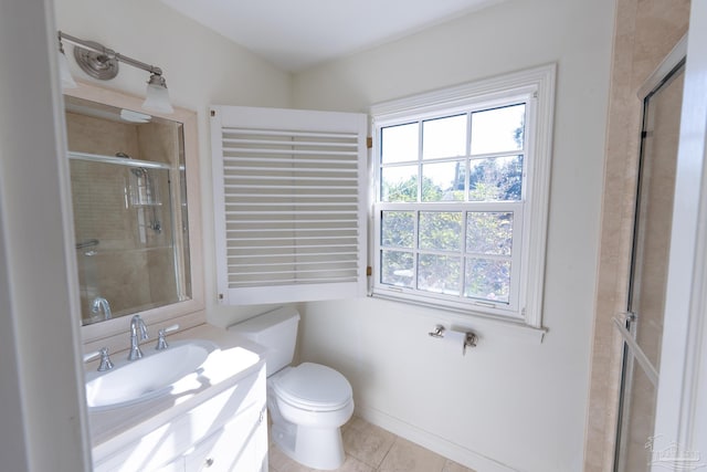 bathroom with tile patterned flooring, vanity, toilet, and a shower with shower door