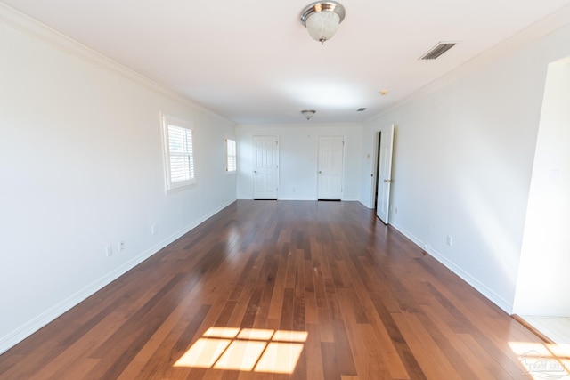 unfurnished room featuring dark hardwood / wood-style floors and ornamental molding