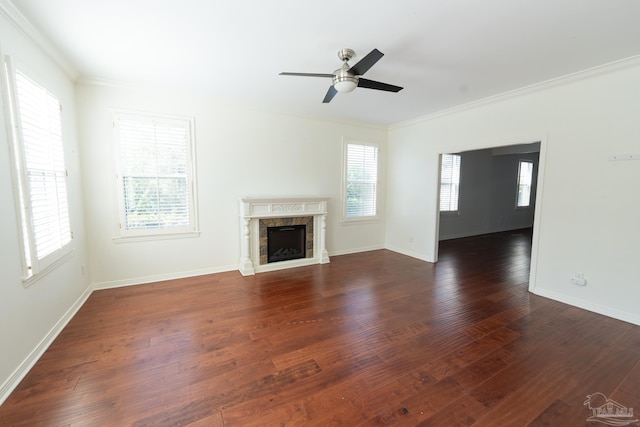 unfurnished living room featuring dark hardwood / wood-style flooring, plenty of natural light, and ornamental molding