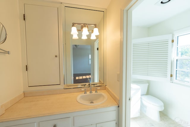 bathroom featuring tile patterned flooring, vanity, and toilet