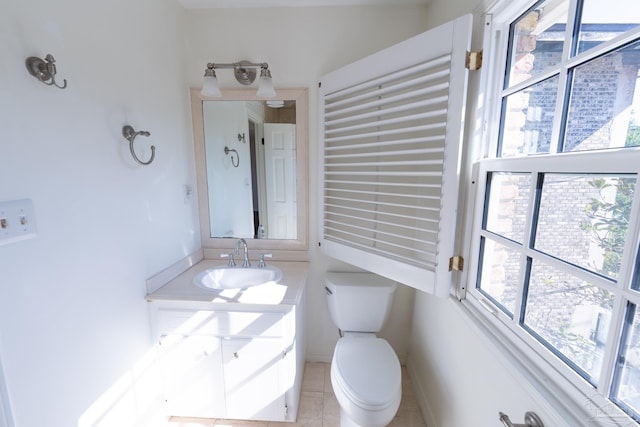 bathroom featuring tile patterned flooring, vanity, and toilet