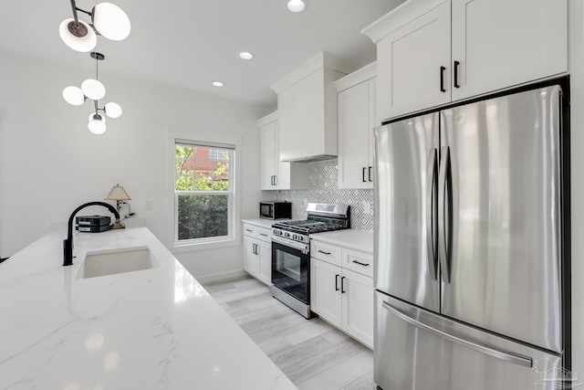 1132 N I St, Pensacola, FL 32501 - kitchen with appliances with stainless steel finishes, white cabinetry, light stone counters, decorative backsplash, and recessed lighting