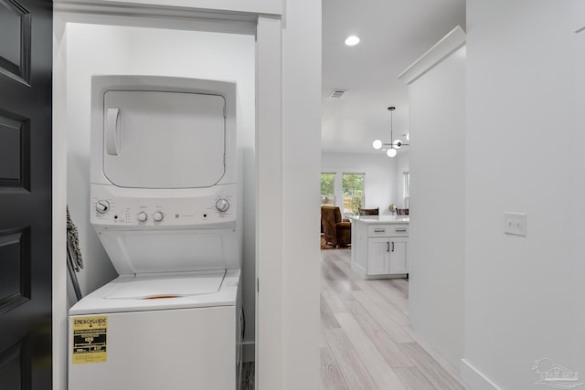 1132 N I St, Pensacola, FL 32501 - washroom featuring stacked washer / drying machine, light wood-style flooring, and recessed lighting