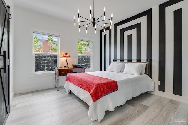 1132 N I St, Pensacola, FL 32501 - bedroom featuring a chandelier and light wood-style flooring