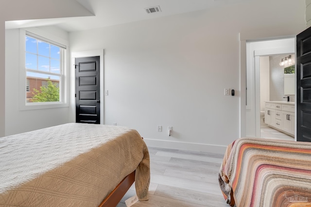 1132 N I St, Pensacola, FL 32501 - bedroom featuring light wood-style flooring and ensuite bath