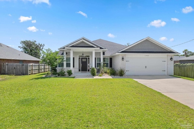 view of front of house featuring fence, an attached garage, concrete driveway, and a front lawn