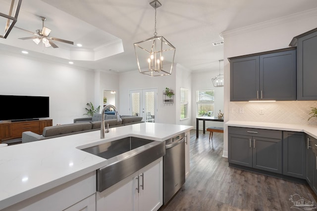 kitchen with a sink, open floor plan, dark wood-type flooring, stainless steel dishwasher, and ornamental molding