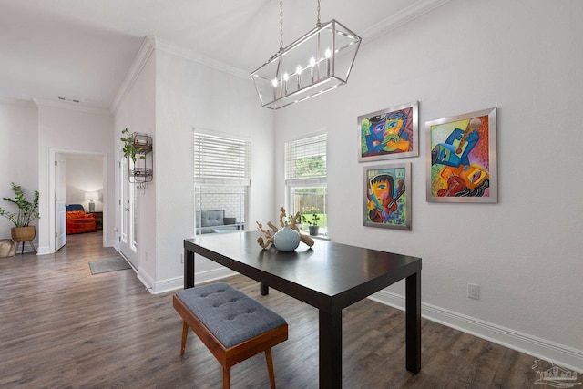 dining area with baseboards, ornamental molding, a notable chandelier, and dark wood-type flooring