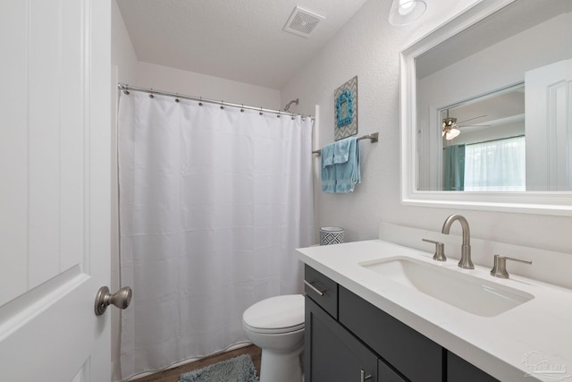 full bathroom with visible vents, a shower with shower curtain, toilet, and vanity