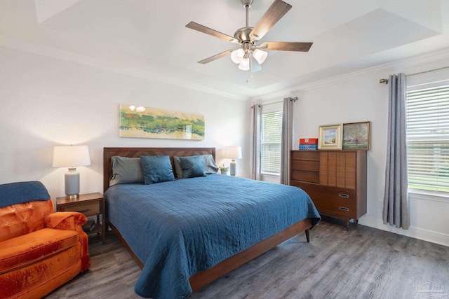 bedroom with baseboards, ornamental molding, ceiling fan, and wood finished floors