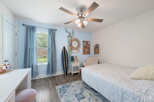 bedroom with baseboards, ceiling fan, and wood finished floors