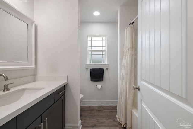 full bathroom with wood finished floors, vanity, baseboards, toilet, and a shower with shower curtain