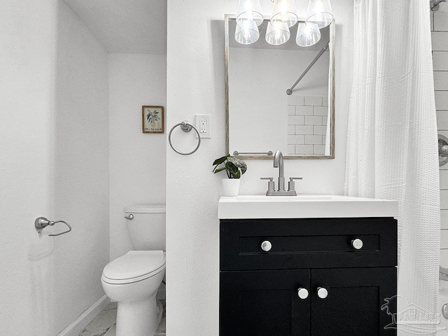 bathroom featuring marble finish floor, toilet, vanity, a shower with curtain, and baseboards