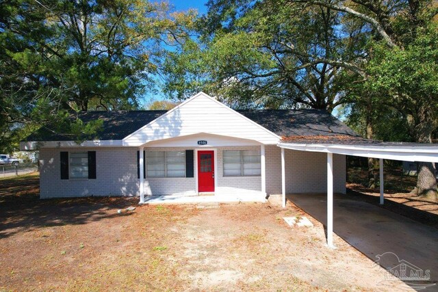 ranch-style home featuring a carport