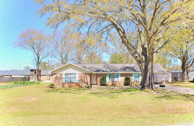 ranch-style house featuring a front yard and fence