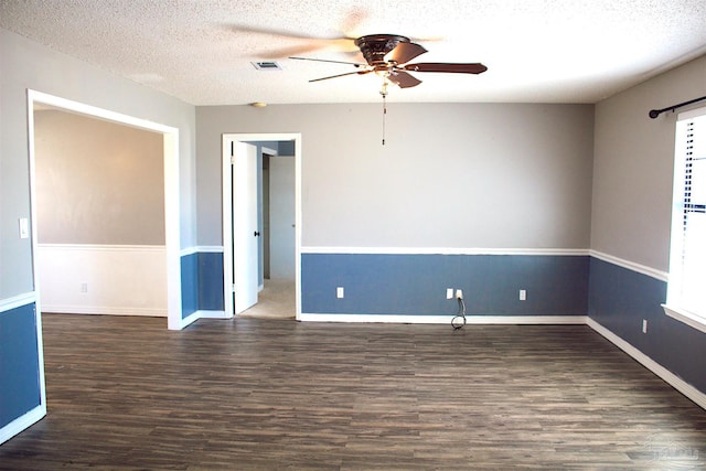 spare room featuring wood finished floors, a textured ceiling, ceiling fan, and visible vents