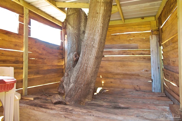 interior space featuring hardwood / wood-style flooring and wooden walls