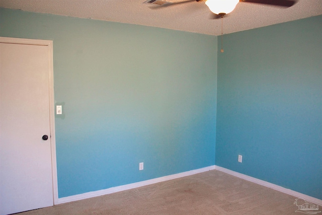 empty room with baseboards, carpet flooring, and a ceiling fan
