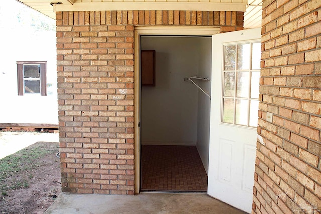 property entrance featuring brick siding