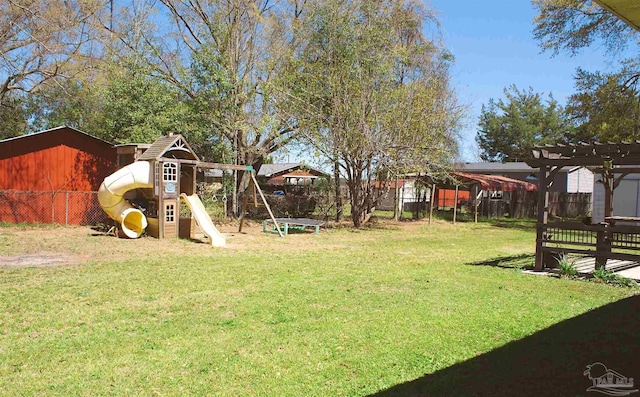 view of yard with a pergola, fence, and a playground