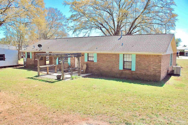 rear view of house with cooling unit, a patio, brick siding, a pergola, and a yard