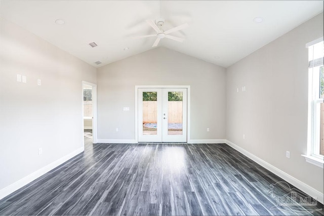 unfurnished room featuring dark wood-style floors, french doors, lofted ceiling, and a healthy amount of sunlight