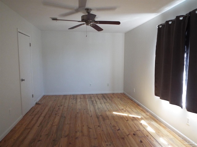 unfurnished room with hardwood / wood-style flooring and ceiling fan