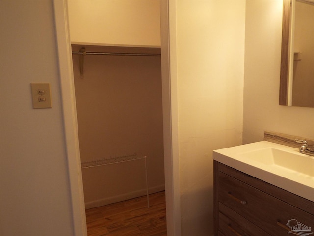 bathroom with vanity and hardwood / wood-style flooring